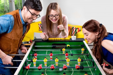 Friends playing table football