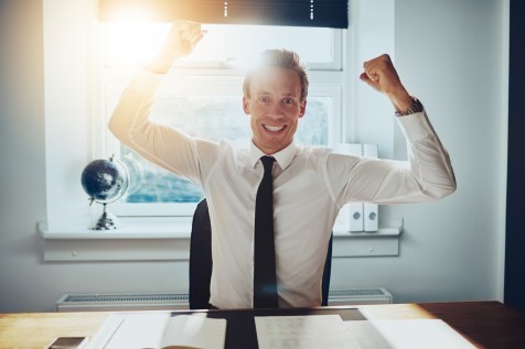 Business man holding arms over head