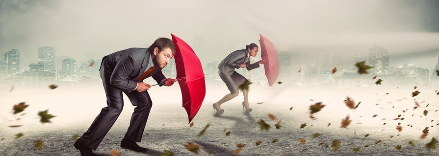 Businessman and businesswoman in storm