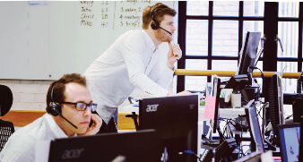 two sales people on the phone at their desks